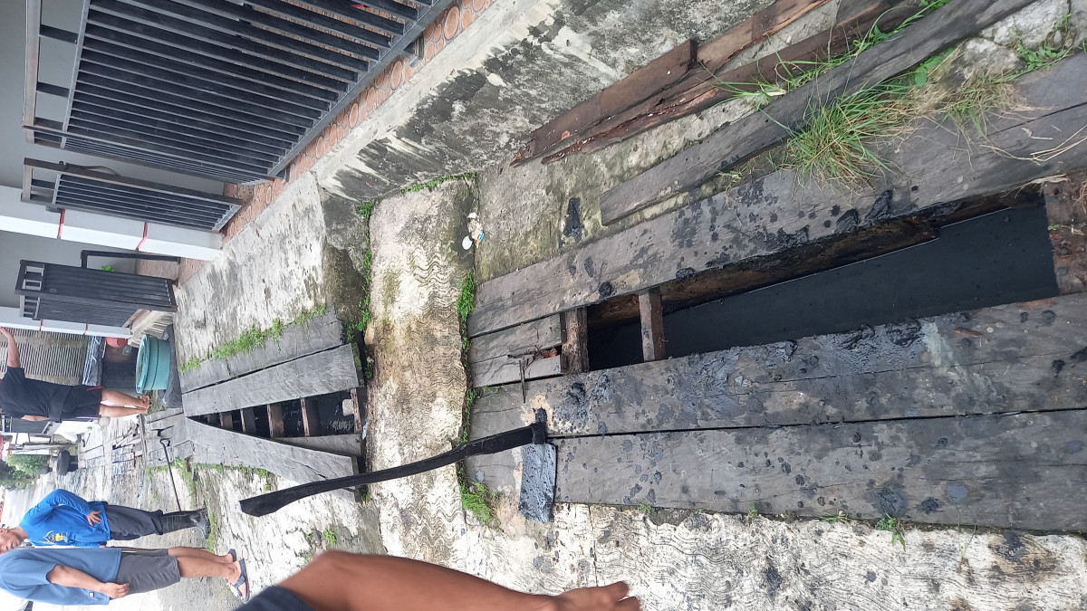 membersihkan parit