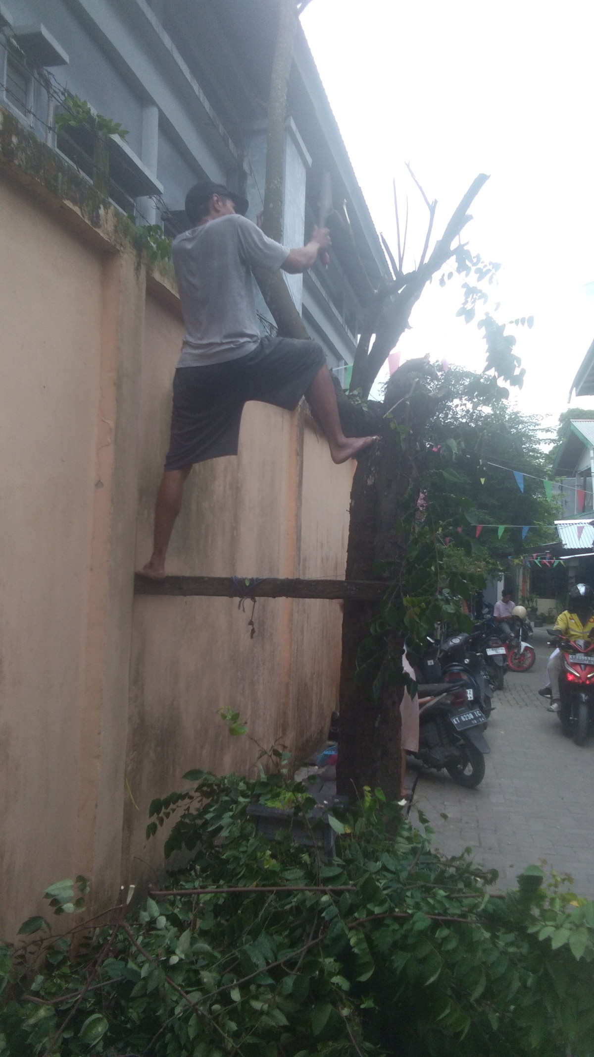 Kegiatan kerja bhakti pangkas pohon belimbing dan membersihkan drainase