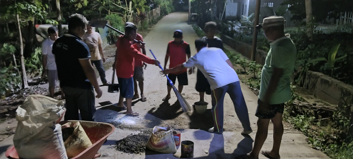 Gotong royong Mengaspal sambungan jalan cor